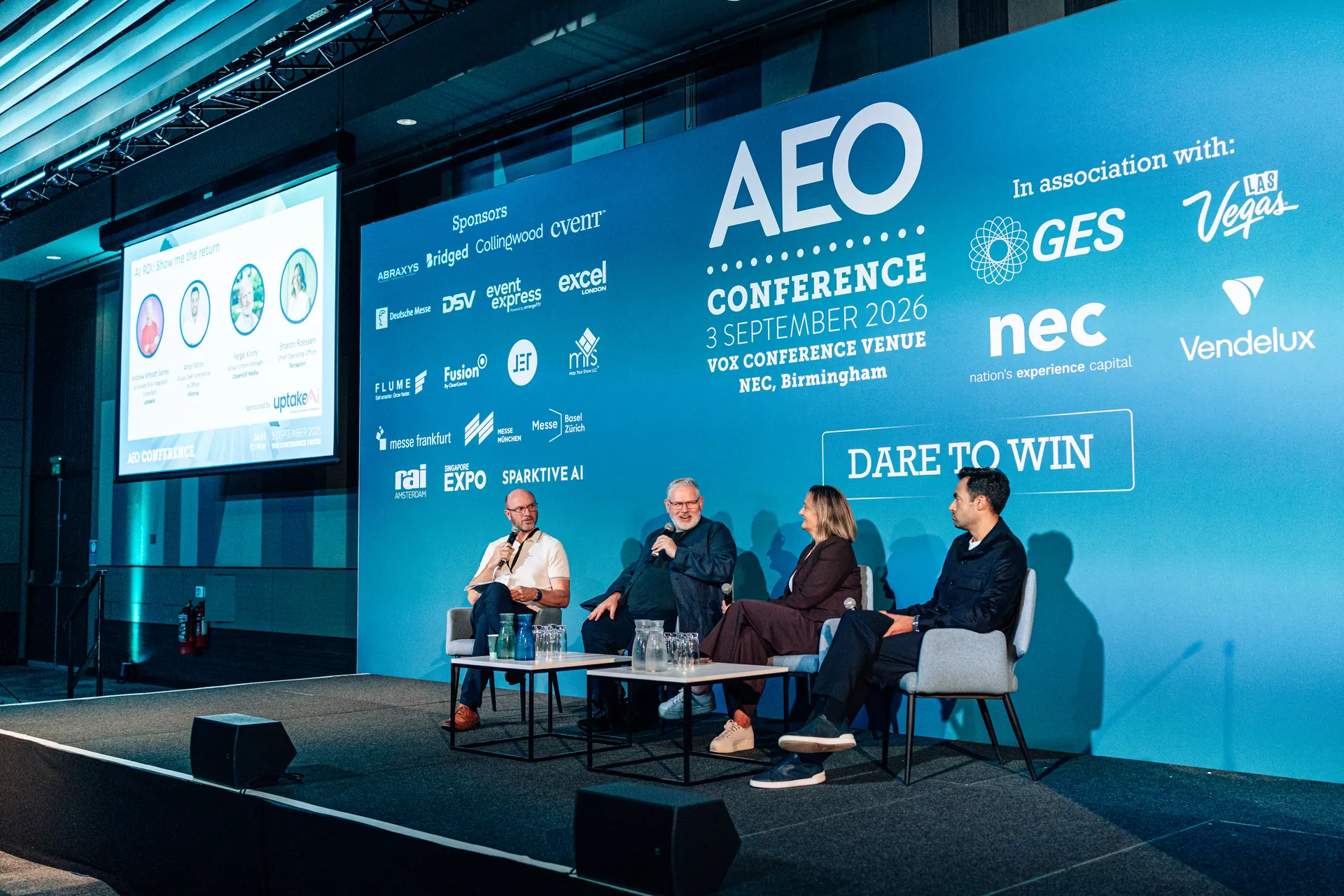 A panel discussion on stage at the AEO Conference 2026