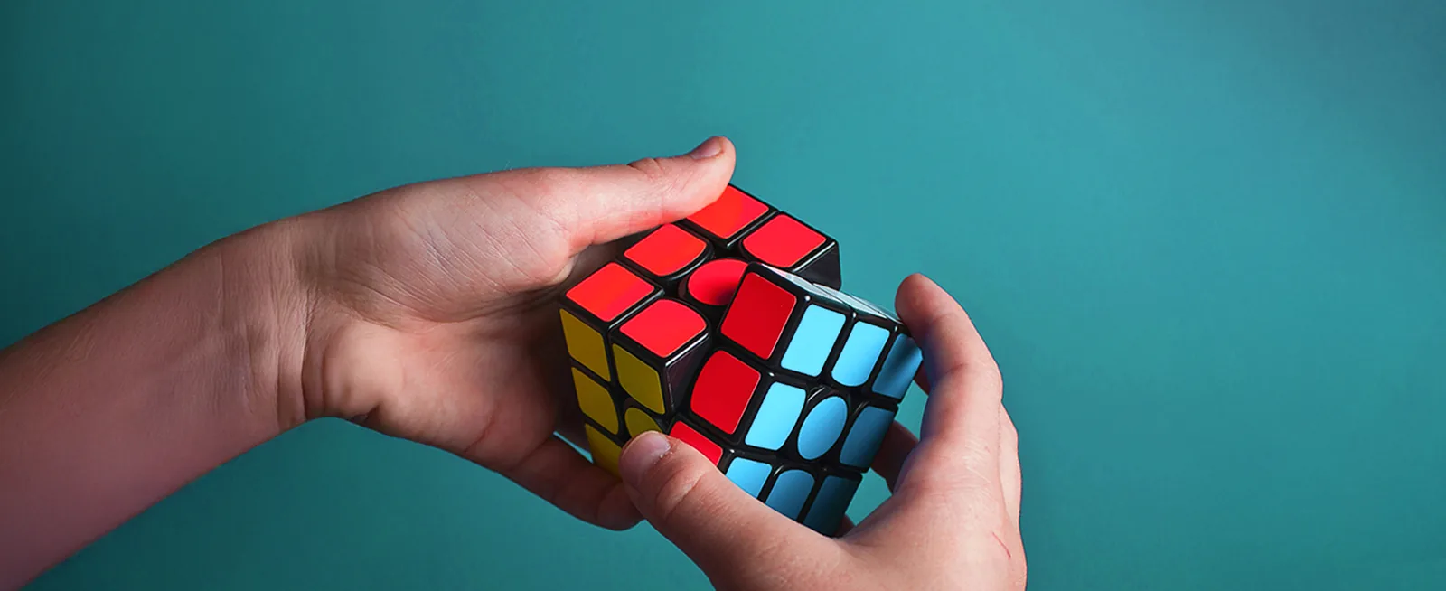 Hands solving a puzzle cube